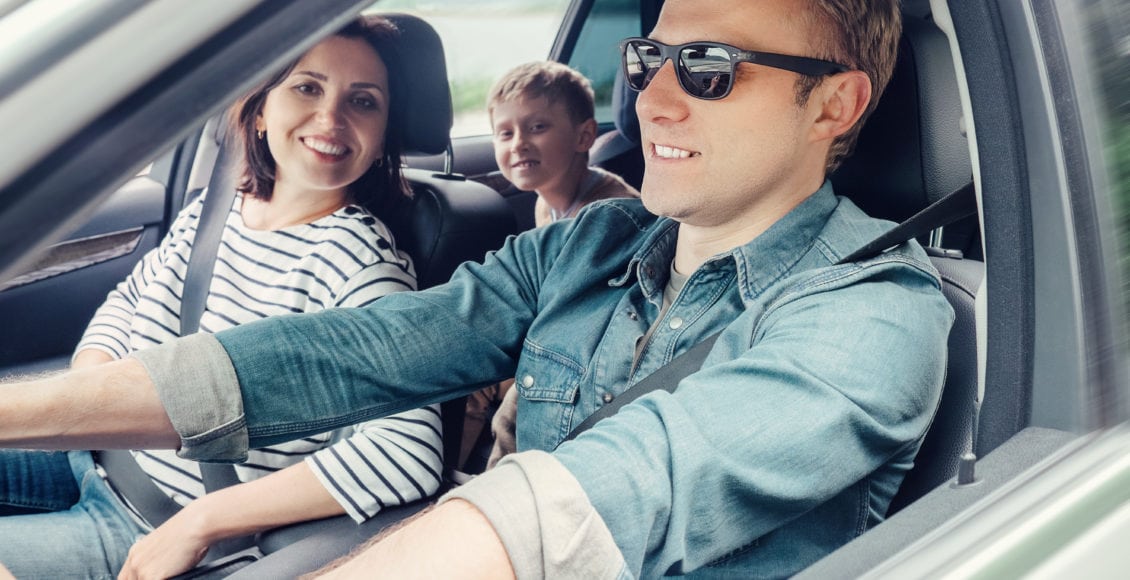 Happy family riding in a car