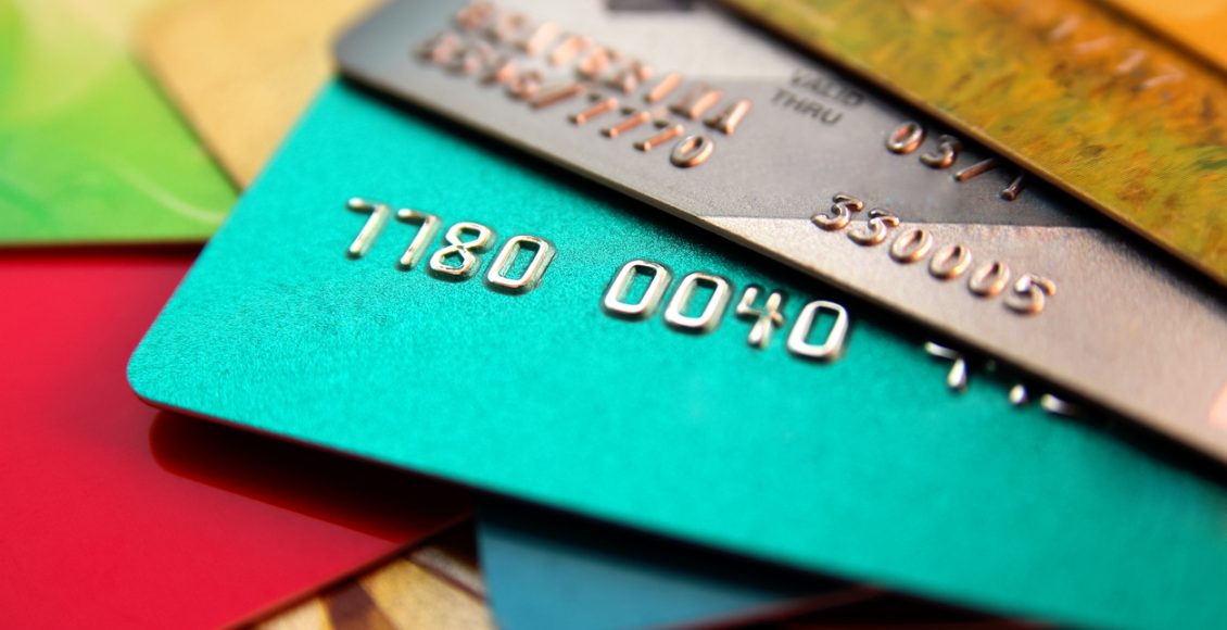 stack of multicolored credit cards, close up view with selective focus