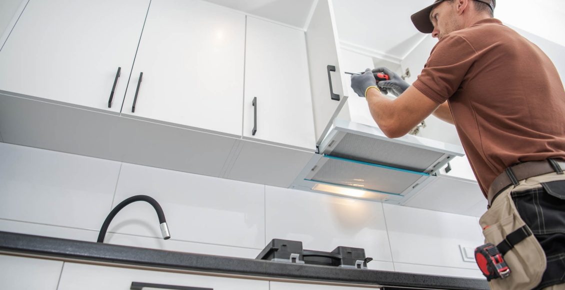 Contractor Worker Assembling of New Apartment Kitchen Cabinets