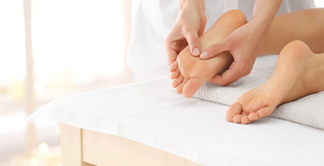 Foot massage in spa salon, closeup