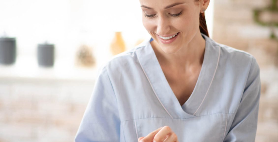 Nurse putting pills and vitamins into special box