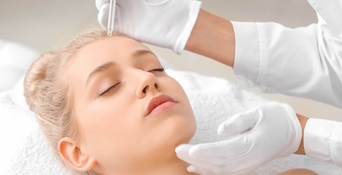 Young woman undergoing treatment in beauty salon