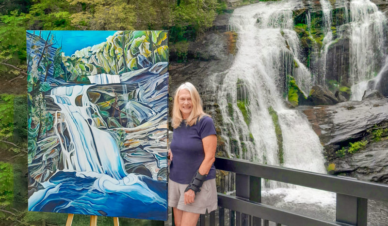 Lyda Best Posing with large painting at water falls